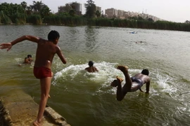 Trẻ em tắm mát trên sông Nile ở thủ đô Cairo, Ai Cập để tránh nắng nóng ngày 15/5 vừa qua. (Ảnh: THX/TTXVN)