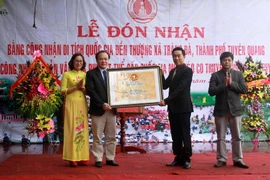 Lãnh đạo tỉnh Tuyên Quang thay mặt Bộ Văn hóa, Thể thao và Du lịch trao Bằng công nhận di tích Quốc gia Đền thượng, xã Tràng Đà, thành phố Tuyên Quang cho đại diện thành phố Tuyên Quang. (Ảnh: Văn Tý./TTXVN)