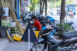 Tình trạng tiểu thương lấn chiếm vỉa hè xuất hiện liên tục trên tuyến đường Giải Phóng, không còn chỗ cho người đi bộ. (Ảnh: Hoài Nam/Vietnam+)