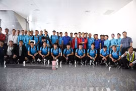 Đội tuyển Việt Nam chụp ảnh lưu niệm với nhân viên mặt đất Vietnam Airlines tại sân bay Nội Bài ngày 7/12. (Ảnh: Hoàng Linh/TTXVN)