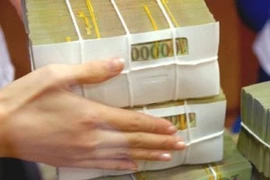 Bộ Tài chính đánh giá thực hiện cả năm 2024, thu ngân sách Nhà nước ước đạt 1.873,3 nghìn tỷ đồng, vượt 10,1% so dự toán Quốc hội giao. (Ảnh: Vietnam+)