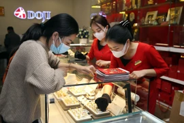 Khách hàng đang giao dịch vàng miếng. (Ảnh: TTXVN)