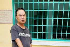 Đối tượng Đinh Thành Hiếu tại cơ quan công an. (Ảnh: TTXVN phát)