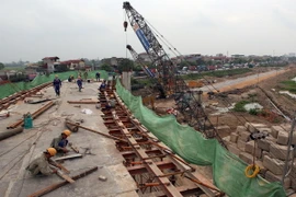 Công nhân làm việc tại một nhánh của nút giao cầu Thanh Trì-Quốc lộ 5. (Ảnh: TTXVN)