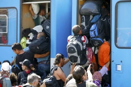 Người di cư chen lên tàu tại nhà ga ở Beli Manastir, Croatia ngày 18/9. (Ảnh: REUTERS/TTXVN)