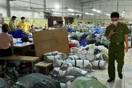 Lực lượng chức năng kiểm tra Công ty trách nhiệm hữu hạn may Đăng Linh HD. (Ảnh: TTXVN)