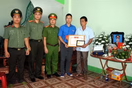 Bí thư Tỉnh đoàn, Chủ tịch Hội Liên hiệp Thanh niên tỉnh Bắc Giang Thân Trung Kiên truy tặng huy hiệu 'Tuổi trẻ dũng cảm' của Trung ương Đoàn cho chiến sỹ công an nghĩa vụ Nguyễn Văn Mạnh hy sinh khi làm nhiệm vụ. (Ảnh: Đồng Thúy/TTXVN)