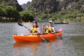 Khách du lịch đến Tràng An (Ninh Bình) sẽ được trải nghiệm sản phẩm mới, chèo thuyền kayak. (Ảnh: TTXVN)