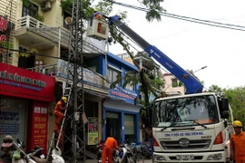 Công nhân đang sửa chữa điện tại thành phố Huế. (Ảnh: Tường Vi/TTXVN)