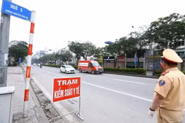 Cảnh sát giao thông hướng dẫn phương tiện dừng xe kiểm soát khi vào nội đô. (Ảnh: Minh Quyết/TTXVN)
