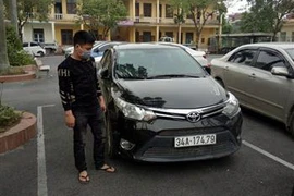 Đối tượng Lê Quang Huy và chiếc xe gây án. (Ảnh: TTXVN)