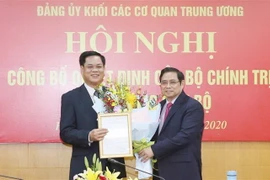 Ông Phạm Minh Chính, Ủy viên Bộ Chính trị, Bí thư Trung ương Đảng, Trưởng Ban Tổ chức Trung ương trao quyết định phân công, điều động ông Huỳnh Tấn Việt làm Phó Bí thư Đảng ủy Khối các cơ quan Trung ương nhiệm kỳ 2015-2020. (Ảnh: Phương Hoa/TTXVN)