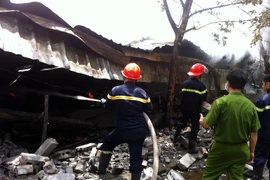 Lính cứu hỏa dập tắt đám cháy. (Ảnh: Mạnh Tú/Vietnam+)