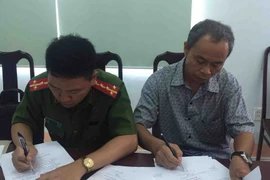 Ông Ngô Quốc Vinh, Giám đốc Ngân hàng Agribank Chi nhánh huyện Krông Bông (bên phải) tại cơ quan công an. (Ảnh: Phạm Cường/TTXVN)