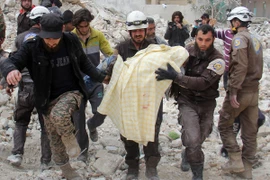 Lực lượng dân phòng Syria chuyển nạn nhân khỏi đống đổ nát sau một đợt không kích ở tỉnh Idlib ngày 15/2. (Nguồn: AFP/TTXVN)