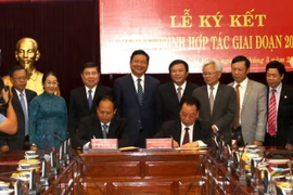 Phó Bí thư Thành ủy Thành phố Hồ Chí Minh Tất Thành Cang và giáo sư, tiến sỹ Phùng Hữu Phú, Phó Chủ tịch Hội đồng Lý luận Trung ương ký kết Chương trình hợp tác giai đoạn 2017-2021. (Ảnh: Thanh Vũ/TTXVN)