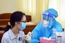 Học sinh trường THPT chuyên Phan Ngọc Hiển (phường 1, thành phố Cà Mau) tiêm vaccine phòng COVID-19. (Ảnh: Huỳnh Anh/TTXVN)