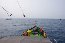 Lực lượng chức năng nỗ lực tìm kiếm các nạn nhân mất tích trong vụ lật sà lan ở Quảng Ngãi. (Ảnh: TTXVN phát)