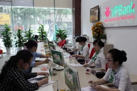 Khách hàng giao dịch tại Hội sở chính VPBank. (Ảnh: Trần Việt/TTXVN)