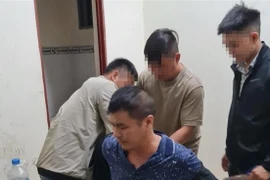 Yang Zhong Wu bị công an bắt giữ. (Ảnh: TTXVN phát)
