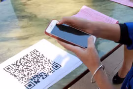 Khách hàng nên đối chiếu thông tin số tài khoản, tên chủ tài khoản với chủ cửa hàng sau khi quét QR thanh toán. (Ảnh minh họa. Nguồn: TTXVN)