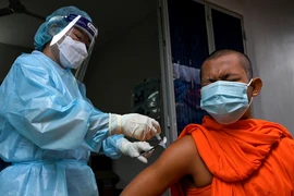 Nhân viên y tế tiêm vaccine ngừa COVID-19 cho nhà sư tại Phnom Penh, Campuchia. Trẻ em dưới 5 tuổi chưa được tiêm vaccine. (Ảnh: AFP/TTXVN)