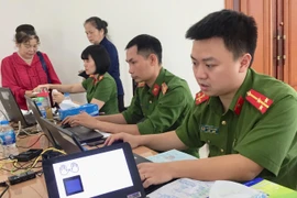 Công an thành phố Hà Nội thực hiện làm thẻ căn cước công dân gắn chíp cho người dân. (Ảnh: Nguyễn Thắng/TTXVN)