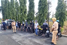 Các “quái xế” cùng phương tiện tụ tập đua xe, cổ vũ đua tại Khu công nghiệp Biên Hòa 2 bị tạm giữ ngày 4/7. (Ảnh: TTXVN phát)