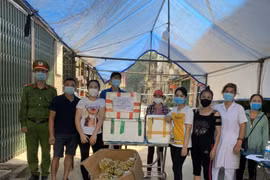 Nhóm Thiện Từ Tâm ở thị trấn Yên Viên, huyện Gia Lâm (Hà Nội) trao quà ủng hộ bà con Tổ dân phố cơ khí Yên Viên bị phong tỏa do dịch COVID-19. (Ảnh: TTXVN phát)
