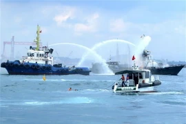Diễn tập tình huống giả định cứu vớt 6 thuyền viên tàu Gia Bảo 68 nhảy xuống biển. (Ảnh: Phước Ngọc/TTXVN)
