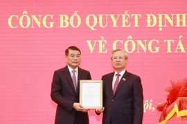 Ông Trần Quốc Vượng, Ủy viên Bộ Chính trị, Thường trực Ban Bí thư trao Quyết định của Bộ Chính trị cho ông Lê Minh Hưng. (Ảnh: Phương Hoa/TTXVN)