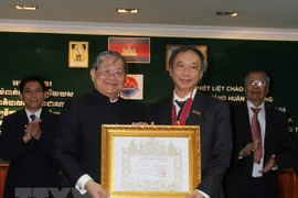 Trưởng Cơ quan thường trú TTXVN tại Phnom Penh, nhà báo Trần Chí Hùng nhận huân chương Hạng Nhất (hạng Thephaden). (Nguồn: TTXVN)