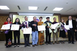 Vụ trưởng Vụ Văn hóa-Văn nghệ Ban Tuyên giáo Trung ương Nguyễn Minh Nhựt và Chủ tịch Hội Văn học nghệ thuật các dân tộc thiểu số Việt Nam Nông Quốc Bình trao giải B cho các tác giả (Không có giải A). (Ảnh: Hoàng Hiếu/TTXVN)