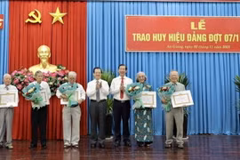 Ông Lê Hồng Quang, Bí thư Tỉnh ủy An Giang trao Huy hiệu 60 năm tuổi Đảng cho các đảng viên. (Ảnh: Thanh Sang/TTXVN)