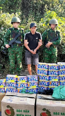 Đối tượng Trần Văn Bình và tang vật 30 hộp pháo hoa nổ bị lực lượng chức năng bắt giữ. (Ảnh: TTXVN phát)