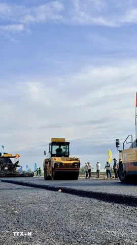Thi công thảm bê tông nhựa trên tuyến chính cao tốc đoạn qua địa bàn phường Vĩnh Tế, tỉnh An Giang. (Ảnh: Thanh Sang/TTXVN)