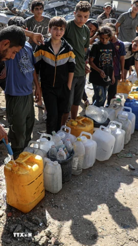 Người dân Palestine xếp hàng chờ lấy nước sinh hoạt tại Shati, phía Tây thành phố Gaza. (Ảnh: THX/TTXVN)