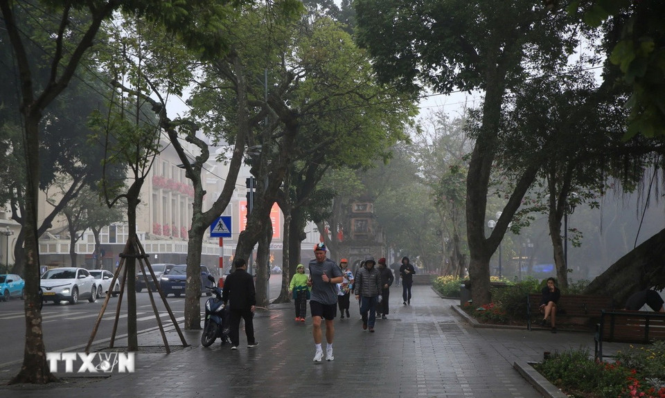 Mưa nhỏ khiến đường ướt và trơn trên đường Đinh Tiên Hoàng. (Ảnh: Mai Hiền/TTXVN phát)