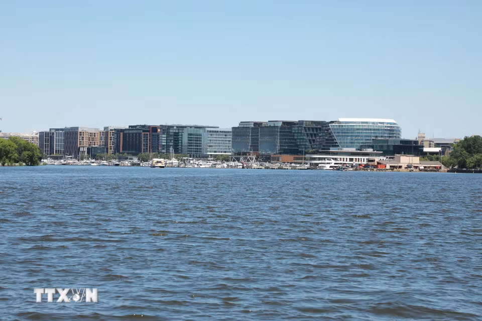 Bến thuyền trên sông Potomac, phía sau là những tòa nhà hiện đại phản chiếu ánh sáng, thể hiện sự kết nối giữa dòng sông lịch sử và diện mạo đô thị phát triển của Washington, D.C. (Ảnh: Ngọc Quang/TTXVN)