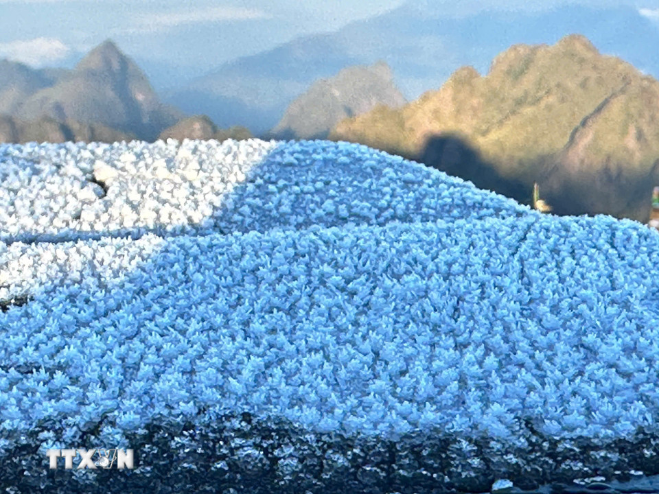 Lớp băng dày khoảng 0,5cm, trắng xốp, bám lên mặt sàn, lan can. (Ảnh: TTXVN phát)