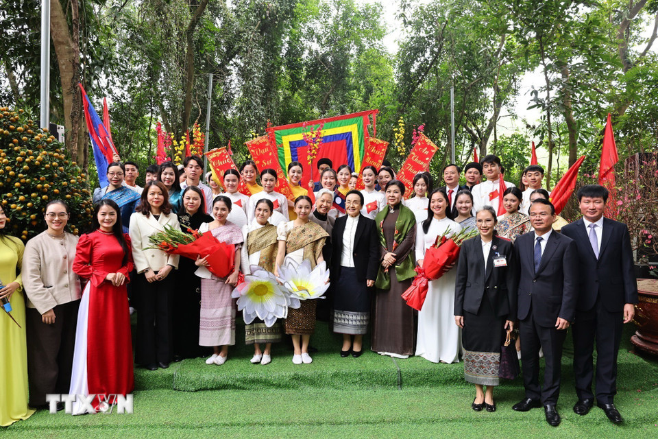 Phu nhân Ngô Phương Ly và Phu nhân Naly Sisoulith tặng hoa cho các sinh viên trường Đại học Hoa Lư sau buổi biểu diễn văn nghệ. (Ảnh: Minh Đức/TTXVN)