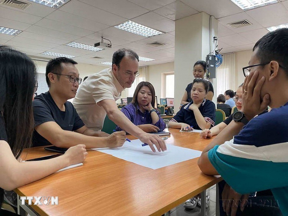 Nhà báo Alain Gérard, Tổng biên tập báo điện tử Latitudes, giảng viên Đại học Tự do Bruxelles (ULB) trao đổi với các học viên về phương thức tổ chức một bài báo hiện đại trên trang thông tin điện tử cho phóng viên, biên tập viên của TTXVN. (Ảnh: TTXVN)