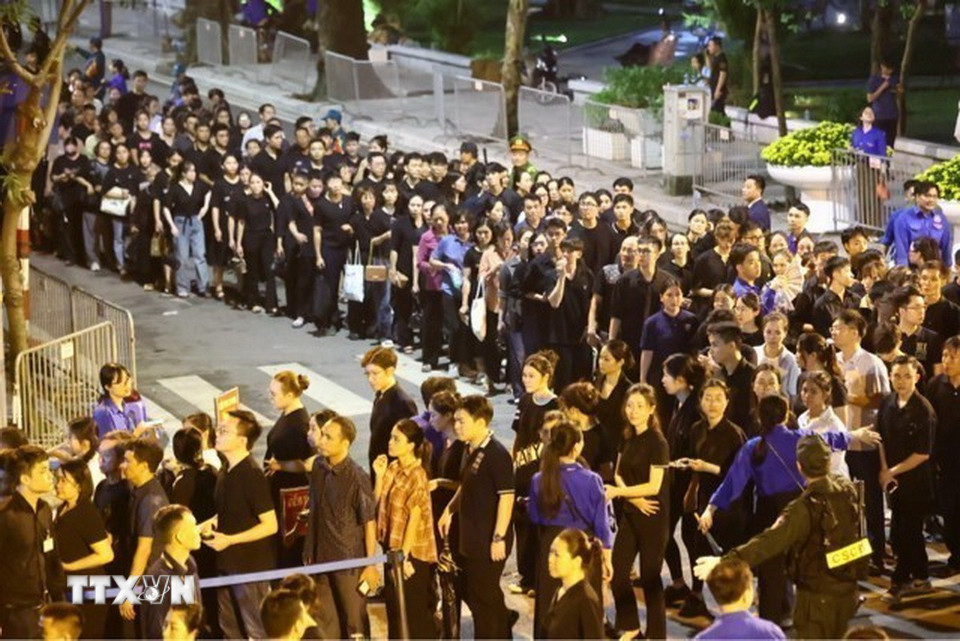 Đến hơn 22h đêm, vẫn còn đoàn dài người dân xếp hàng chờ đến lượt vào viếng Tổng Bí thư Nguyễn Phú Trọng. (Ảnh: TTXVN)