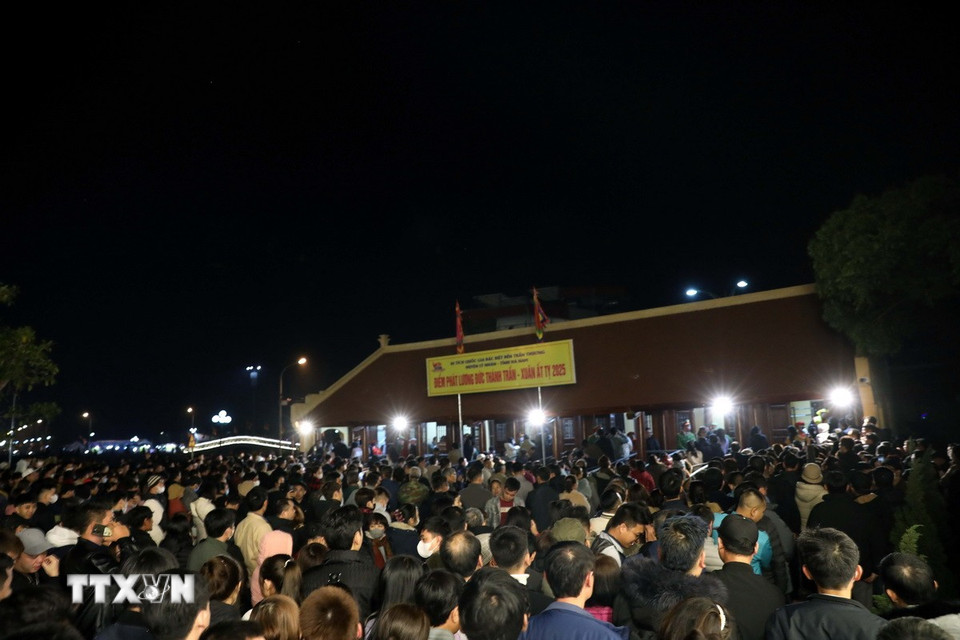 Hàng ngàn người dân địa phương và du khách xếp hàng để đón nhận túi lương từ các điểm phát của Đền. (Ảnh: Đại Nghĩa/TTXVN)