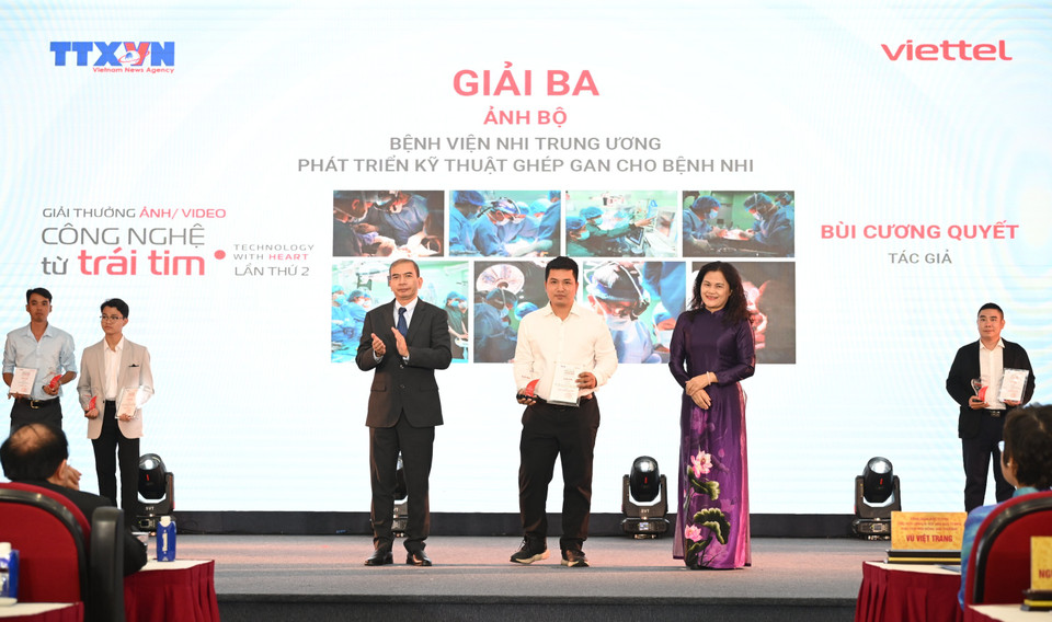 Phóng viên Bùi Cương Quyết của Ban Biên tập Ảnh, Thông tấn xã Việt Nam nhận giải thưởng về công nghệ ghép gan cho bệnh nhi. (Ảnh: Nhật Minh/Vietnam+)