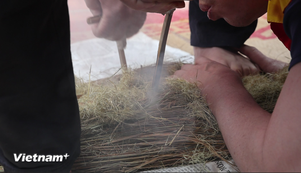 Một đội chơi cật lực thổi cho lửa bùng lên, nhóm bếp nấu cơm. (Ảnh: Minh Anh/Vietnam+)