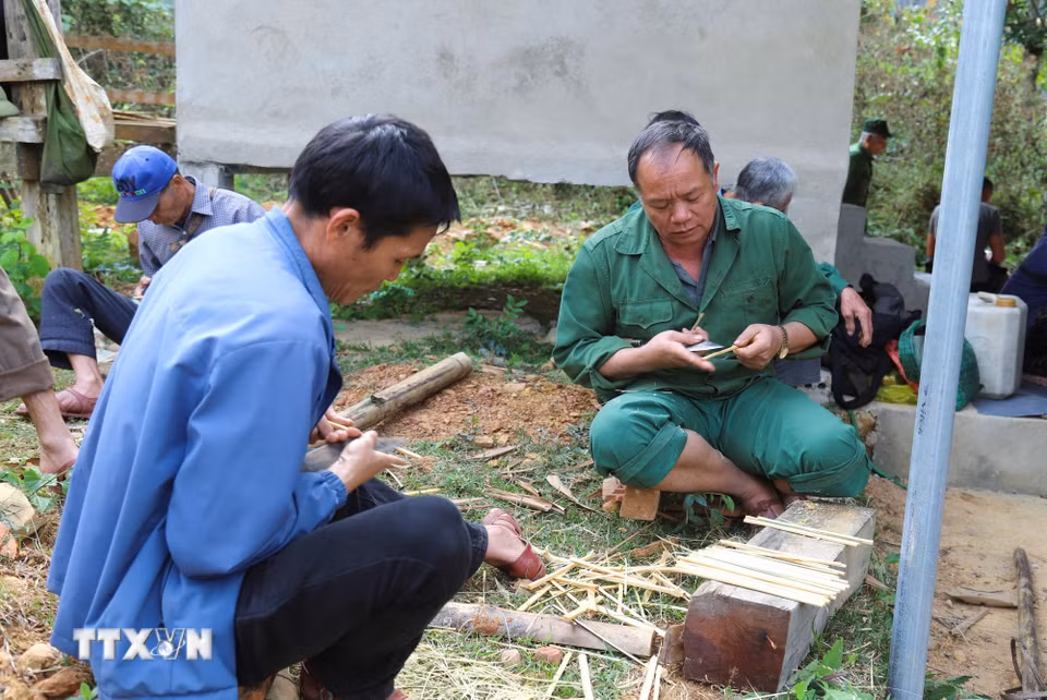 Đàn ông khéo tay được lựa chọn để chẻ tre, vót đũa để tạo nên những đôi đũa trơn, thẳng, đều phục vụ việc dâng cúng và để mọi người sử dụng khi thụ hưởng lộc đền sau khi lễ cúng hoàn tất. (Ảnh: Xuân Tiến/TTXVN)