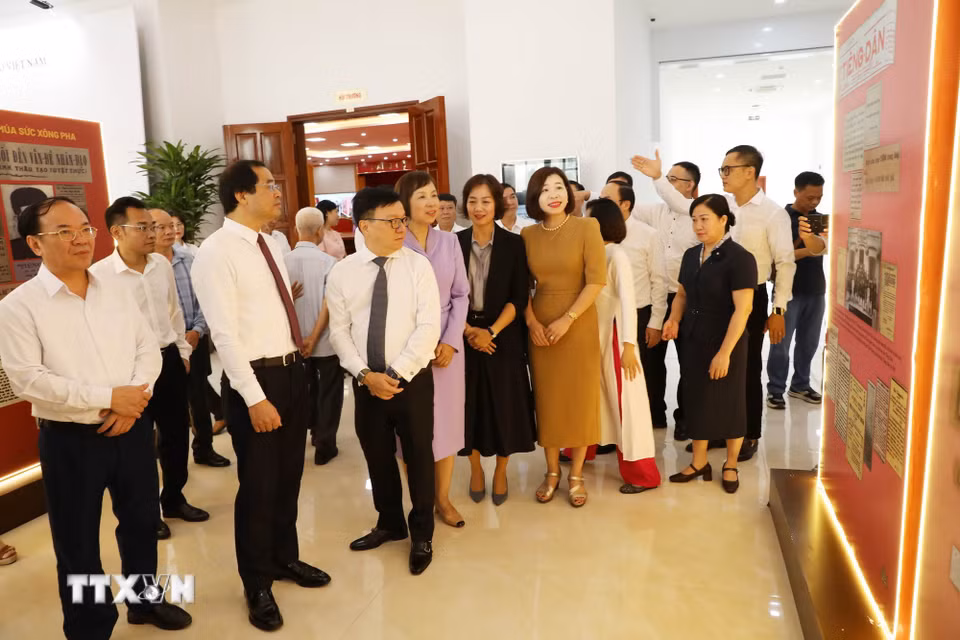 Đại biểu tìm hiểu thông tin về nhà chiến sỹ yêu nước Huỳnh Thúc Kháng tại khu trưng bày sự kiện. (Ảnh: Vũ Hoàng Giang/TTXVN)