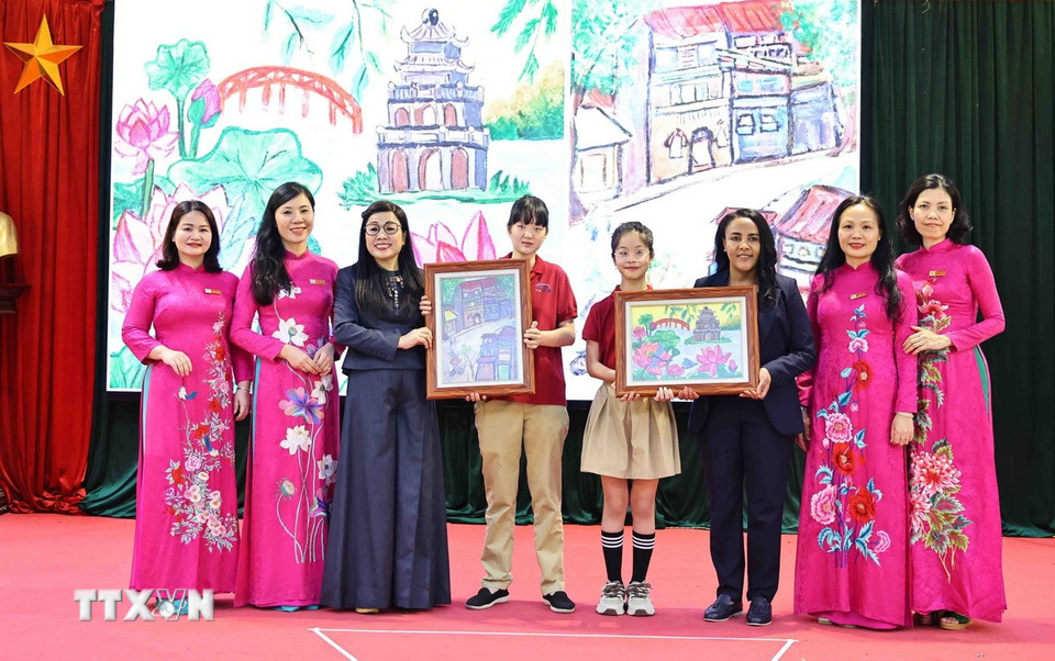 Học sinh Trường PTCS Nguyễn Đình Chiểu tặng tranh cho bà Lê Thị Bích Trân, Phu nhân Thủ tướng Phạm Minh Chính, và bà Zinash Tayachew, Phu nhân Thủ tướng Ethiopia. (Ảnh: Minh Đức/TTXVN)