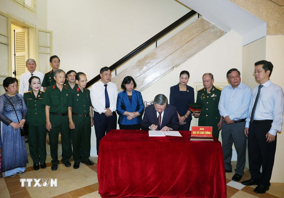 Tổng Bí thư Tô Lâm viết sổ lưu niệm tại Di tích Nhà số 48 Hàng Ngang. (Ảnh: Thống Nhất/TTXVN)